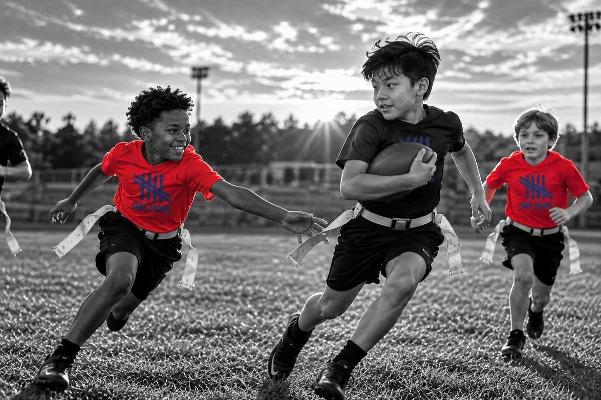 Boys playing flag football and reaching for a flag